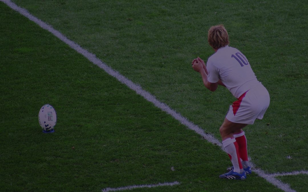 A rugby player prepares to take an important kick at goal